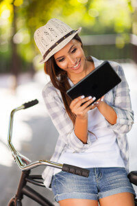 young woman checking email outside